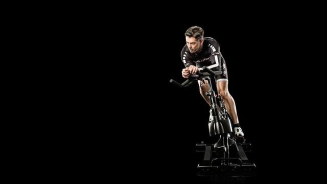 Cyclist on a SoulCycle bike during an intense ride